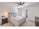 Cozy bedroom with soft carpeting, a comfortable bed, a ceiling fan and a bright window at 7232 N Decatur Blvd # 4, Las Vegas, NV 89131