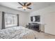 Serene bedroom featuring a television, window with natural light, and neutral color scheme at 7232 N Decatur Blvd # 4, Las Vegas, NV 89131