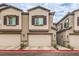 Newer construction townhome featuring a two-car garage and desert landscaping at 7232 N Decatur Blvd # 4, Las Vegas, NV 89131