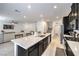 Bright kitchen showcasing a large center island with sink, black cabinetry, and stainless steel appliances at 7232 N Decatur Blvd # 4, Las Vegas, NV 89131