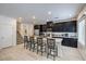 Modern kitchen featuring black cabinets, a central island with bar seating, and stainless steel appliances at 7232 N Decatur Blvd # 4, Las Vegas, NV 89131