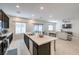 Open-concept kitchen flowing into the living room, featuring a large island with a sink and barstools at 7232 N Decatur Blvd # 4, Las Vegas, NV 89131