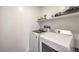 Bright laundry room featuring a white washer and dryer with a shelf above at 7232 N Decatur Blvd # 4, Las Vegas, NV 89131