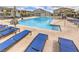 Resort-style community pool with lounge chairs, covered seating areas, and pristine blue water at 7232 N Decatur Blvd # 4, Las Vegas, NV 89131