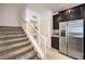 Carpeted staircase leading upstairs, with stainless steel refrigerator and modern cabinetry at 7232 N Decatur Blvd # 4, Las Vegas, NV 89131