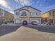 Inviting townhome featuring a private balcony, three garage doors, and desert landscaping at 7525 Emerald Stars St # 101, North Las Vegas, NV 89084