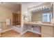 A well lit bathroom with a spacious vanity and a separate bath and shower at 8000 W Badura Ave # 1130, Las Vegas, NV 89113