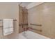 Bright bathroom with updated shower head, grab bars, and a white towel hanging on the towel bar at 8000 W Badura Ave # 1130, Las Vegas, NV 89113