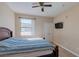 A bright bedroom featuring a ceiling fan, and a mounted TV at 8000 W Badura Ave # 1130, Las Vegas, NV 89113