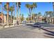 Gated community entrance with palm trees and well-maintained brick paved streets at 8000 W Badura Ave # 1130, Las Vegas, NV 89113
