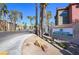 Serenade Palms Condominium Homes entrance with desert landscaping and towering palm trees along the drive at 8000 W Badura Ave # 1130, Las Vegas, NV 89113