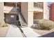 Apartment building exterior featuring stairways, desert landscaping, and neutral colors at 8000 W Badura Ave # 1130, Las Vegas, NV 89113