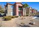 Exterior view of condo units showcasing architectural design, private balconies, and well-maintained landscaping at 8000 W Badura Ave # 1130, Las Vegas, NV 89113
