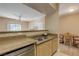 A bright kitchen with granite countertops that opens to the dining and living areas at 8000 W Badura Ave # 1130, Las Vegas, NV 89113
