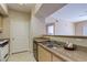 A bright kitchen showcasing a stainless steel sink and granite countertops at 8000 W Badura Ave # 1130, Las Vegas, NV 89113