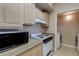 Kitchen features modern appliances next to a laundry room at 8000 W Badura Ave # 1130, Las Vegas, NV 89113