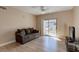 Living room with hardwood floors, a ceiling fan, and sliding glass doors to a balcony at 8000 W Badura Ave # 1130, Las Vegas, NV 89113