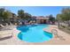 Community pool with pool house and lounge chairs, a perfect spot for relaxation at 8000 W Badura Ave # 1130, Las Vegas, NV 89113
