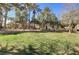 View of a grassy yard area with mature trees in a well maintained apartment community at 8000 W Badura Ave # 1130, Las Vegas, NV 89113