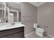 Bathroom with a modern vanity, toilet, and a towel rack, with a door visible in the background at 8495 Green Alder Ct, Las Vegas, NV 89113