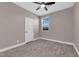 Bedroom with neutral paint, wood-look tile flooring, ceiling fan and natural light from a single window at 8495 Green Alder Ct, Las Vegas, NV 89113