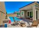 Inviting backyard with a sparkling pool, patio seating, and stylish outdoor decor, perfect for relaxation at 8525 Stokestone St, Las Vegas, NV 89166