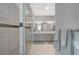 Bathroom featuring double sink vanity, walk-in shower with glass door and decorative tile accent at 8525 Stokestone St, Las Vegas, NV 89166