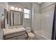 Bathroom with granite countertops, a window, a toilet, a sink, and a bathtub at 8525 Stokestone St, Las Vegas, NV 89166