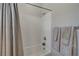The bathroom has a white tiled shower, brushed metal fixtures, and neutral colored towels at 8525 Stokestone St, Las Vegas, NV 89166