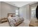 This bedroom has light walls, white floors, a wood bed frame, and a bedside table at 8525 Stokestone St, Las Vegas, NV 89166