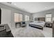 Bright bedroom featuring multiple windows, a neutral color palette and round rug at 8525 Stokestone St, Las Vegas, NV 89166