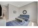This bonus bedroom is a relaxing space with a blue futon, large window and sleek media cabinet at 8525 Stokestone St, Las Vegas, NV 89166