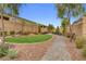 Scenic neighborhood common area features a walking path, small lawn, and well maintained landscaping at 8525 Stokestone St, Las Vegas, NV 89166