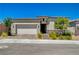 Charming single-story home featuring a two-car garage, brick driveway, stone accents and landscaped front yard at 8525 Stokestone St, Las Vegas, NV 89166