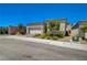 View of a single story home featuring neutral stucco, stone accents, brick driveway and a two car garage at 8525 Stokestone St, Las Vegas, NV 89166