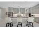 Bright kitchen featuring stainless steel appliances, a quartz countertops and a large island with seating at 8525 Stokestone St, Las Vegas, NV 89166