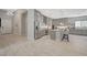 Bright kitchen featuring grey cabinets, stainless steel appliances, a tile floor, and a large island with bar seating at 8525 Stokestone St, Las Vegas, NV 89166