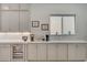 Kitchen area with modern cabinets, granite countertops, a beverage fridge, and a window at 8525 Stokestone St, Las Vegas, NV 89166