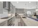 Spacious modern kitchen featuring stainless steel appliances, quartz countertops, and custom cabinetry at 8525 Stokestone St, Las Vegas, NV 89166