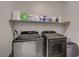 The laundry room features a shelf with supplies and a washer and dryer at 8525 Stokestone St, Las Vegas, NV 89166