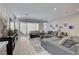 Bright living room features comfortable seating, a TV and view of pool through large sliding glass doors at 8525 Stokestone St, Las Vegas, NV 89166