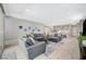 Spacious living room with sliding glass door, tile flooring, and views into the kitchen at 8525 Stokestone St, Las Vegas, NV 89166