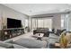 The living room boasts an entertainment center, comfortable seating and sliding doors to a backyard at 8525 Stokestone St, Las Vegas, NV 89166