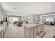 Bright, open-concept living space featuring a modern kitchen with an island and a comfortable seating area at 8525 Stokestone St, Las Vegas, NV 89166