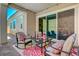 Charming covered patio with outdoor seating and a view into the home at 8525 Stokestone St, Las Vegas, NV 89166