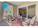 Charming covered patio with outdoor seating and a view into the home at 8525 Stokestone St, Las Vegas, NV 89166