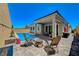 The backyard has a pool, desert landscaping, and plenty of lounge seating at 8525 Stokestone St, Las Vegas, NV 89166