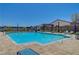 A spacious swimming pool with lounge chairs and umbrellas in a private, fenced-in area at 8525 Stokestone St, Las Vegas, NV 89166