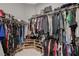 Walk-in closet with ample storage space for hanging clothes, folded items and shoes at 8525 Stokestone St, Las Vegas, NV 89166