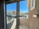 Balcony view of a complex with parking, landscaping and blue skies at 8777 W Maule Ave # 2167, Las Vegas, NV 89148